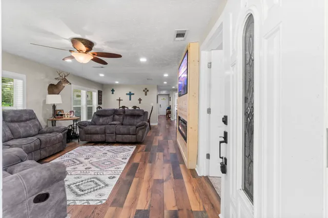 a living room with furniture and a chandelier