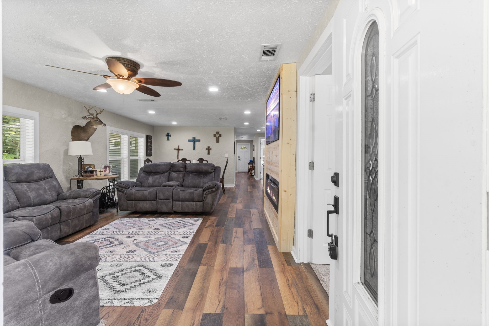 a living room with furniture and a chandelier