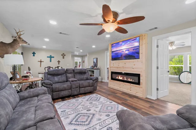 a living room with furniture a fireplace and a chandelier