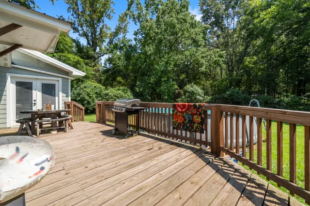 a view of balcony with wooden floor and seating space