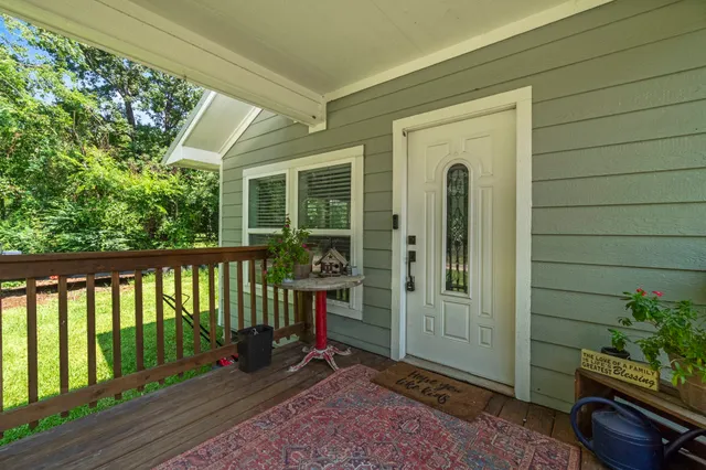 a view of a porch with a table and chairs