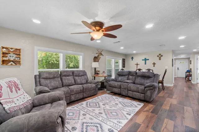 a living room with furniture and a wooden floor