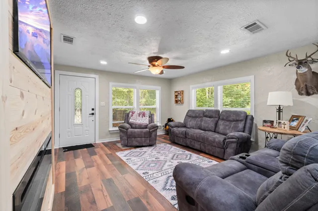 a living room with furniture and a large window