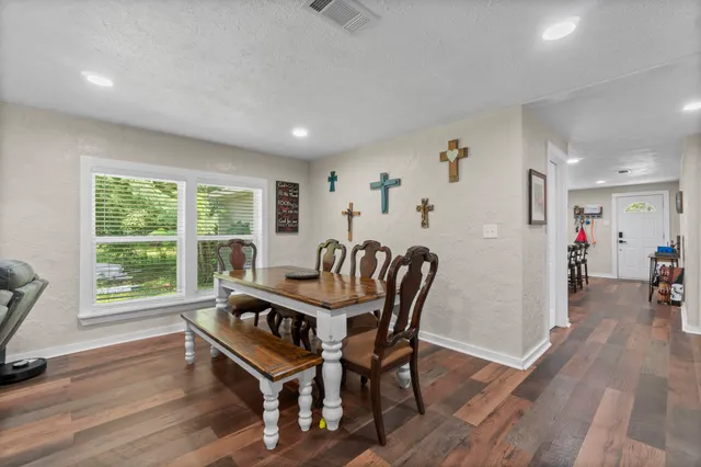 a view of a dining room with furniture and a wooden floor