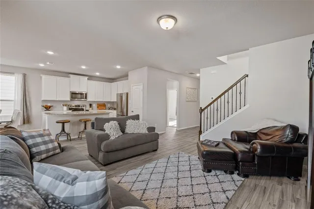 a living room with furniture and kitchen view