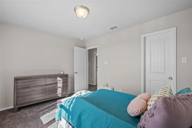 a bedroom with a bed and a dresser