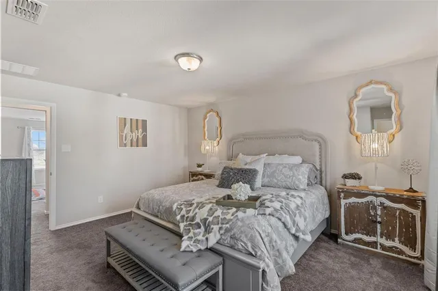 a bedroom with a bed and a potted plant