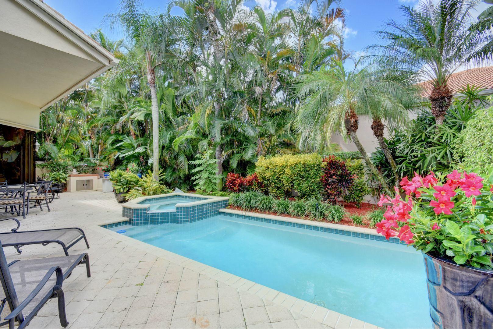 6053 Northwest 42nd Way Boca Raton, FL 33496 - Photo 19 of 23 a view of yard with seating area and garden