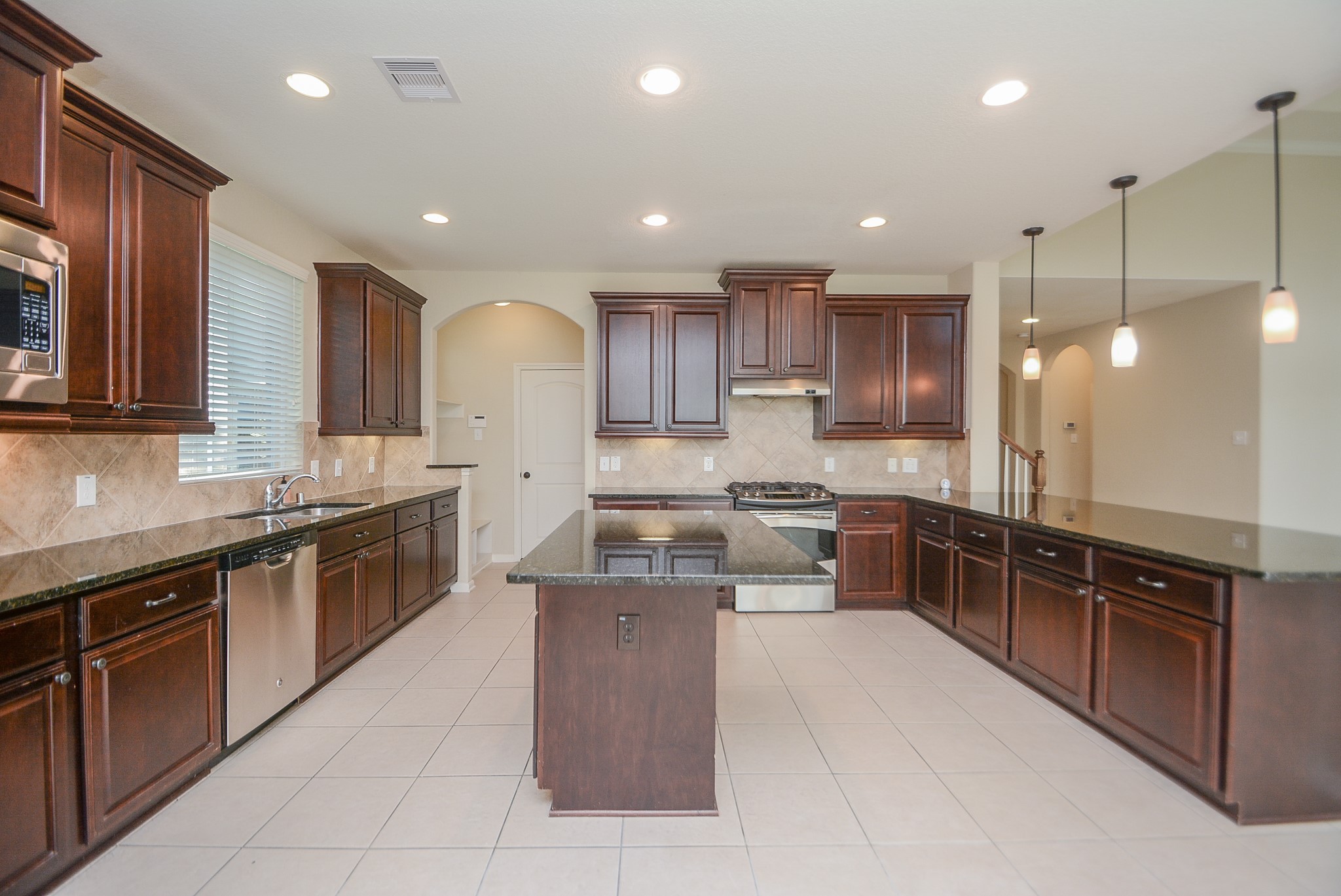 50 Sawbridge Court Spring, TX 77389 - Photo 12 of 32 a large kitchen with stainless steel appliances lots of counter space sink and cabinets