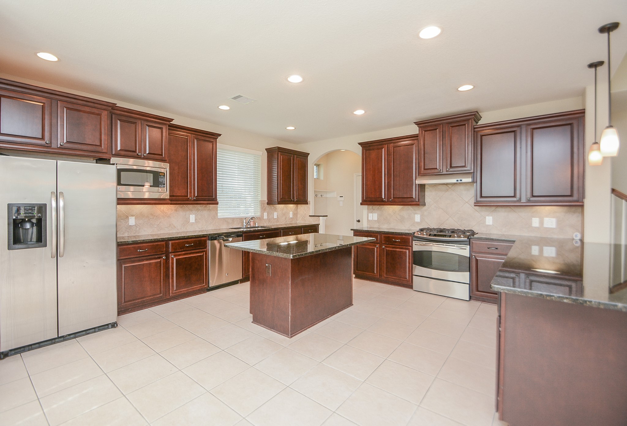 50 Sawbridge Court Spring, TX 77389 - Photo 13 of 32 a large kitchen with stainless steel appliances and a refrigerator