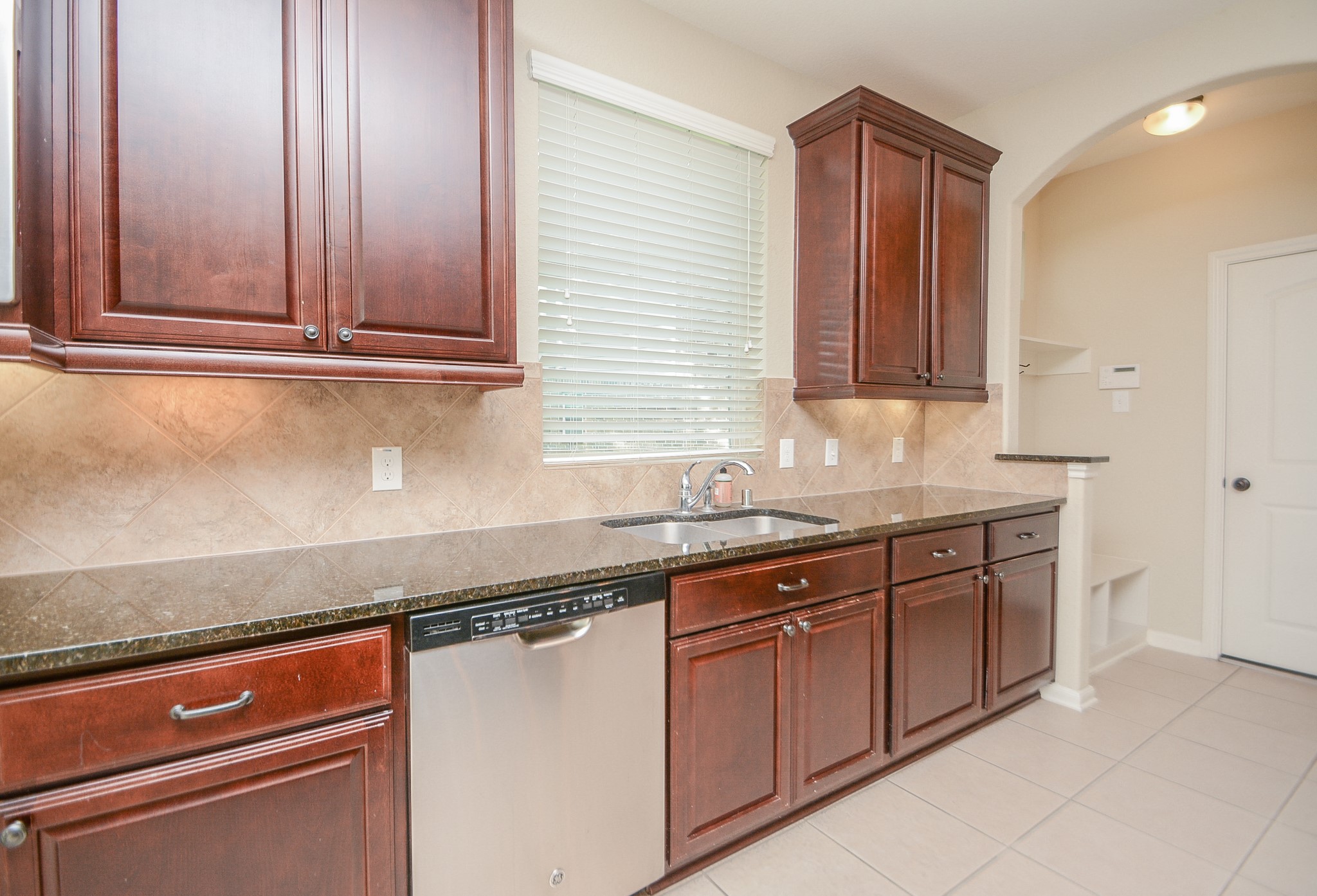 50 Sawbridge Court Spring, TX 77389 - Photo 14 of 32 a kitchen with stainless steel appliances granite countertop a sink and cabinets