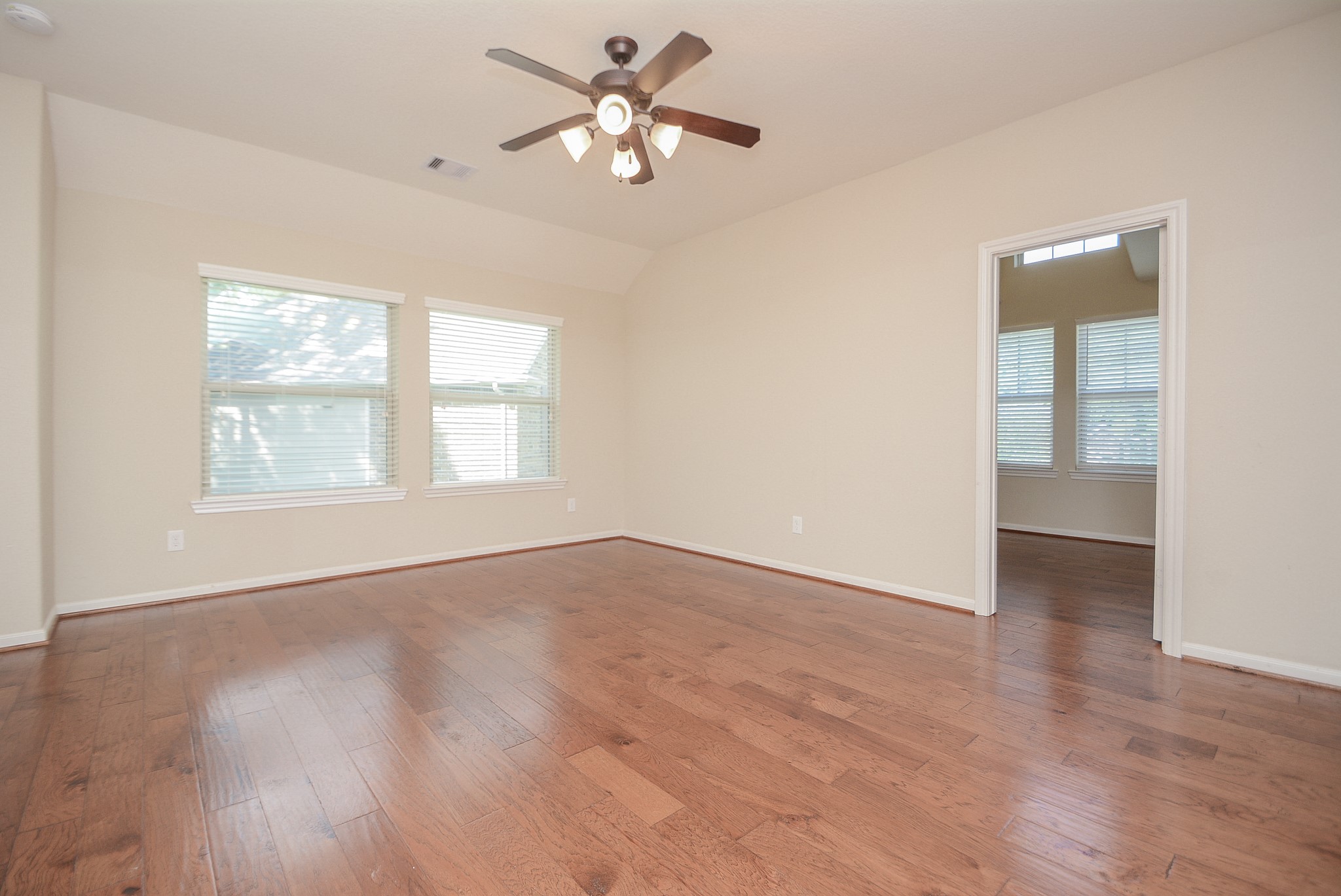 50 Sawbridge Court Spring, TX 77389 - Photo 21 of 32 an empty room with wooden floor chandelier fan and windows