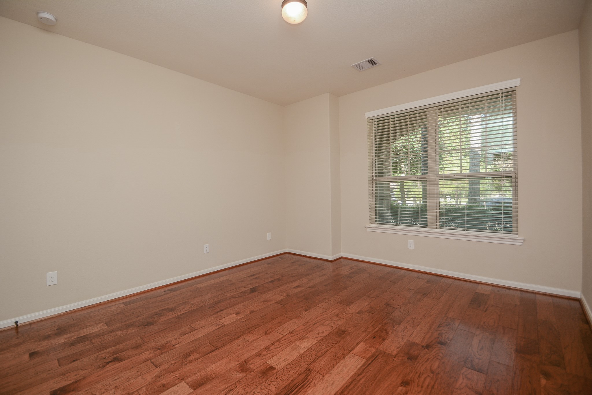 50 Sawbridge Court Spring, TX 77389 - Photo 22 of 32 wooden floor in an empty room with a window