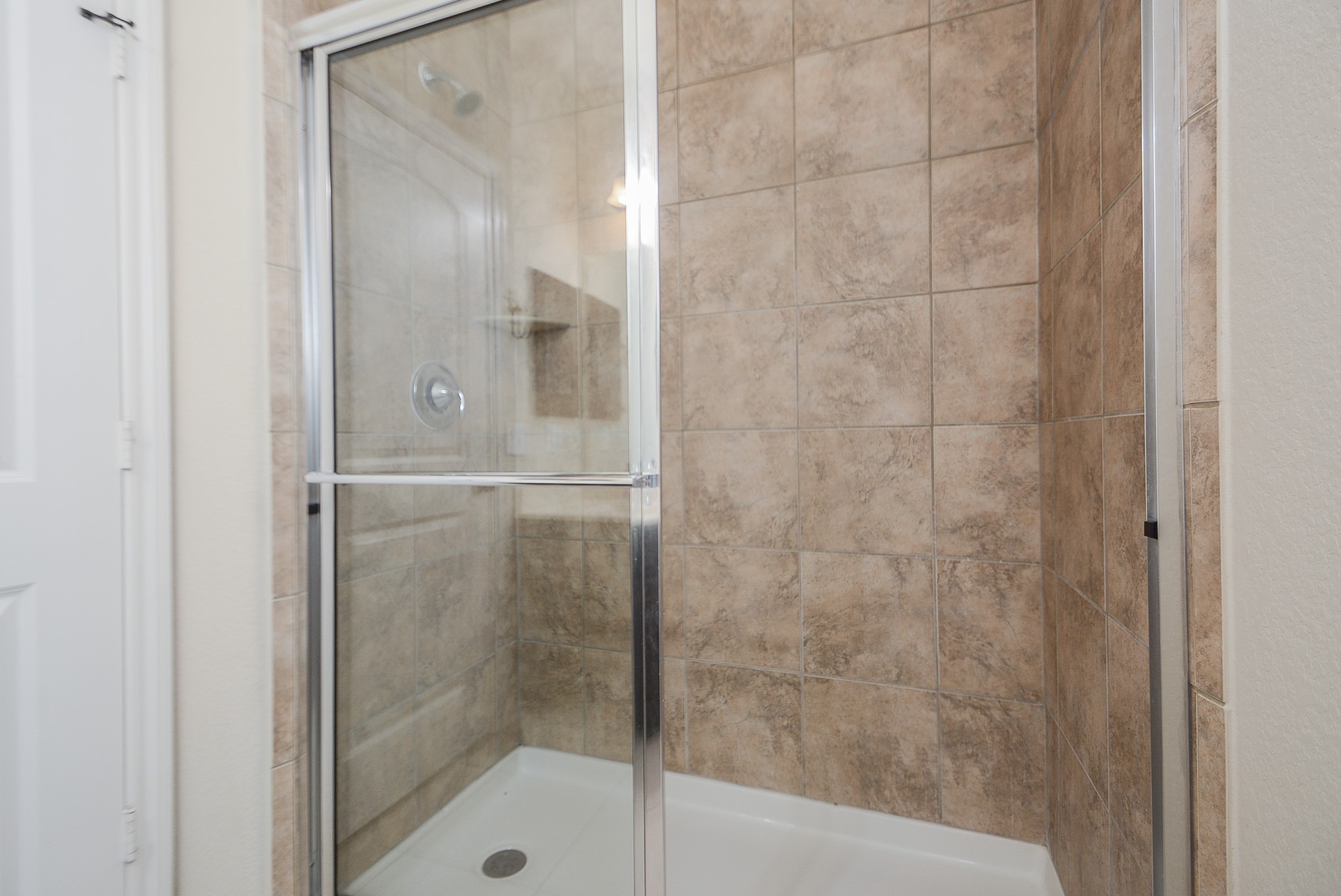 50 Sawbridge Court Spring, TX 77389 - Photo 25 of 32 a bathroom with a glass shower door