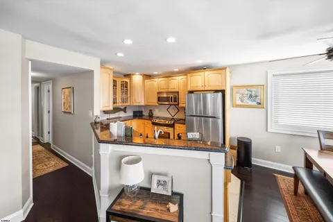 a bathroom with a granite countertop sink a large mirror and a window