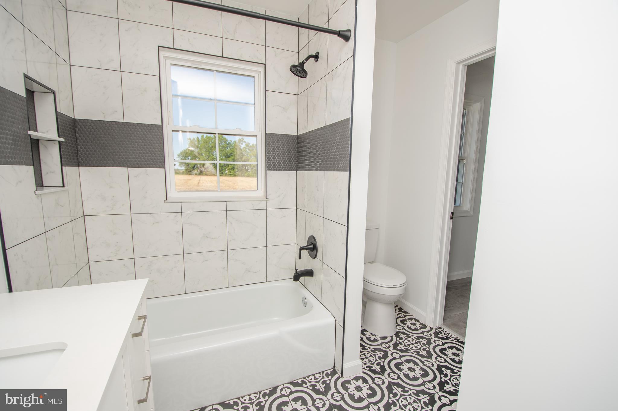 8707 Bacons Road Laurel, DE 19956 - Photo 11 of 18 a bathroom with a bathtub and a shower