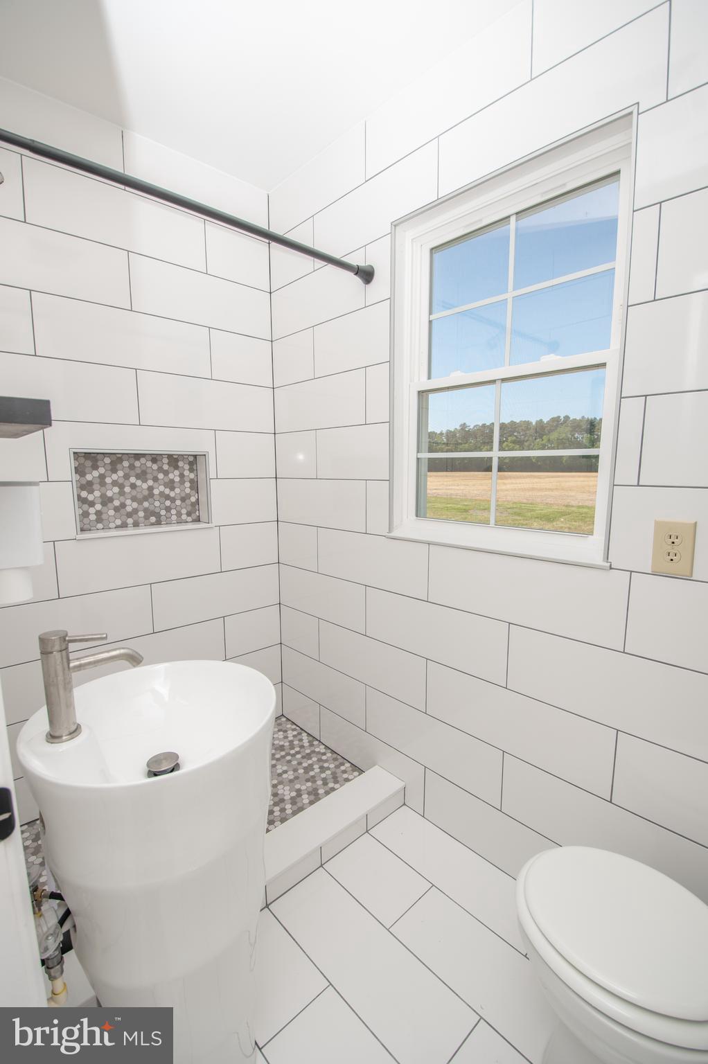 8707 Bacons Road Laurel, DE 19956 - Photo 8 of 18 a bathroom with a toilet and a sink