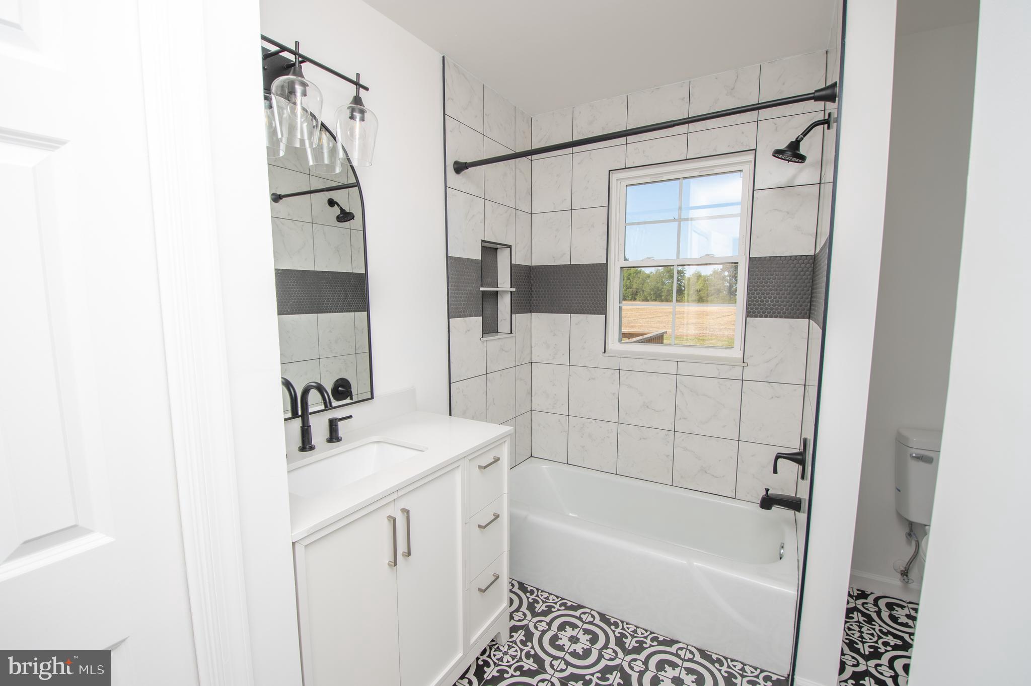 8707 Bacons Road Laurel, DE 19956 - Photo 9 of 18 a bathroom with a sink a mirror and a bathtub