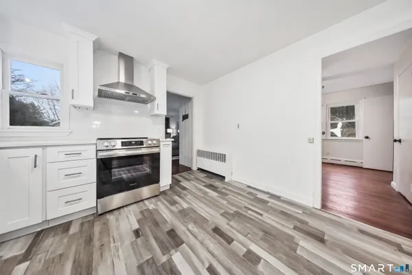 a bathroom with a sink a toilet a mirror and shower