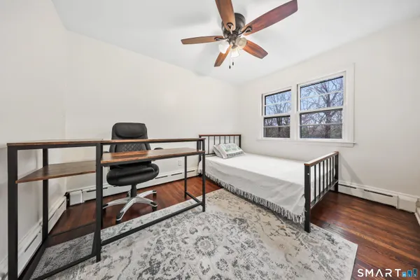 a bedroom with a bed and a night stand