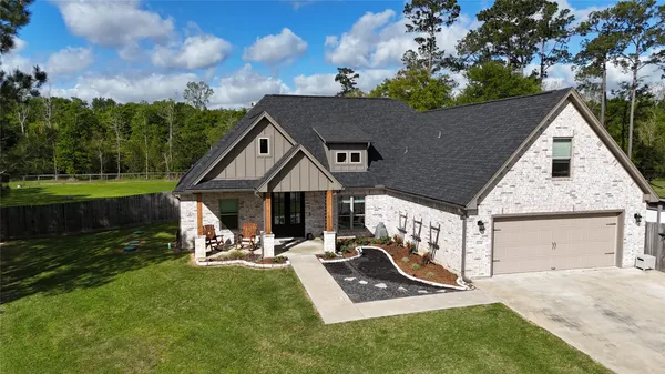 a view of a house with backyard porch and sitting area