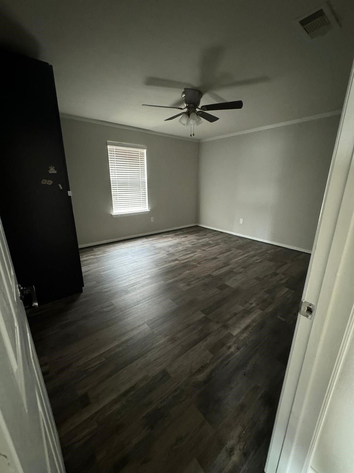 25614 Crisp Spring Lane Spring, TX 77373 - Photo 13 of 25 en empty room with wooden floor and fan