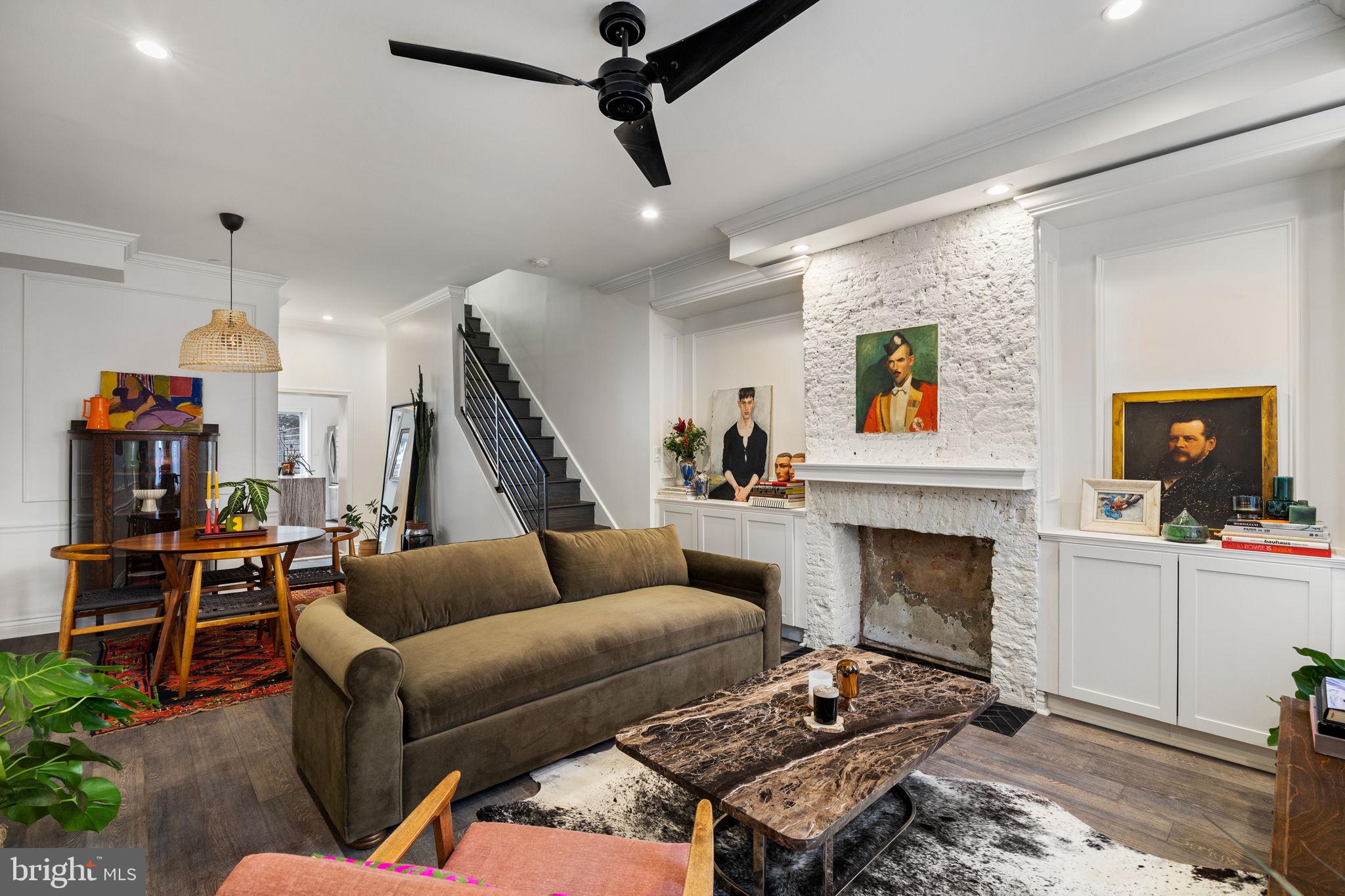 1418 East Columbia Avenue Philadelphia, PA 19125 - Photo 1 of 3 a living room with furniture and a fireplace