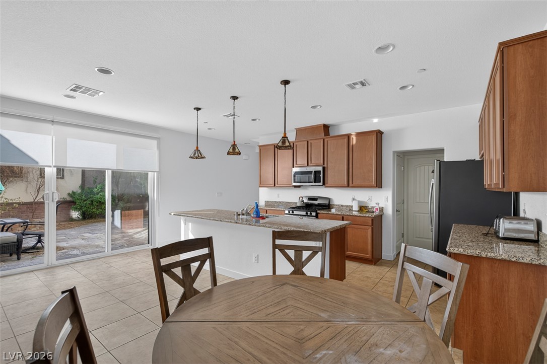 1100 East Sunset Road Henderson, NV 89011 - Photo 11 of 58 Granite counters and stainless steel appliances complete this well-appointed kitchen, ideal for daily meals and entertaining.