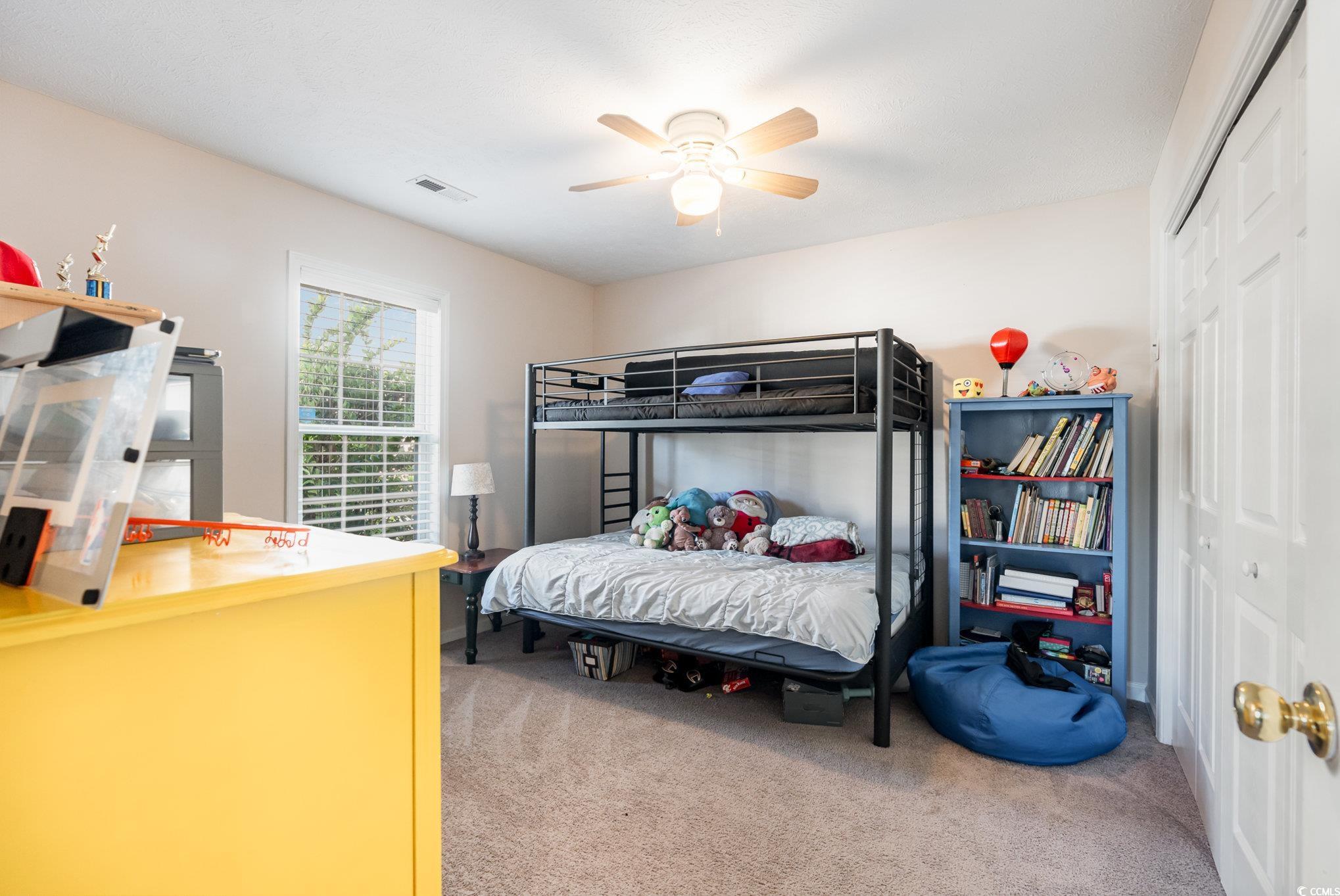1005 Autumn Drive Murrells Inlet, SC 29576 - Photo 19 of 25 Bedroom with ceiling fan, a closet, and carpet
