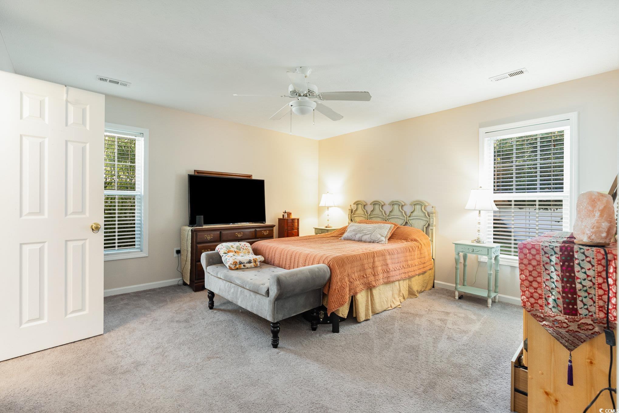 1005 Autumn Drive Murrells Inlet, SC 29576 - Photo 22 of 25 Bedroom with ceiling fan and light colored carpet
