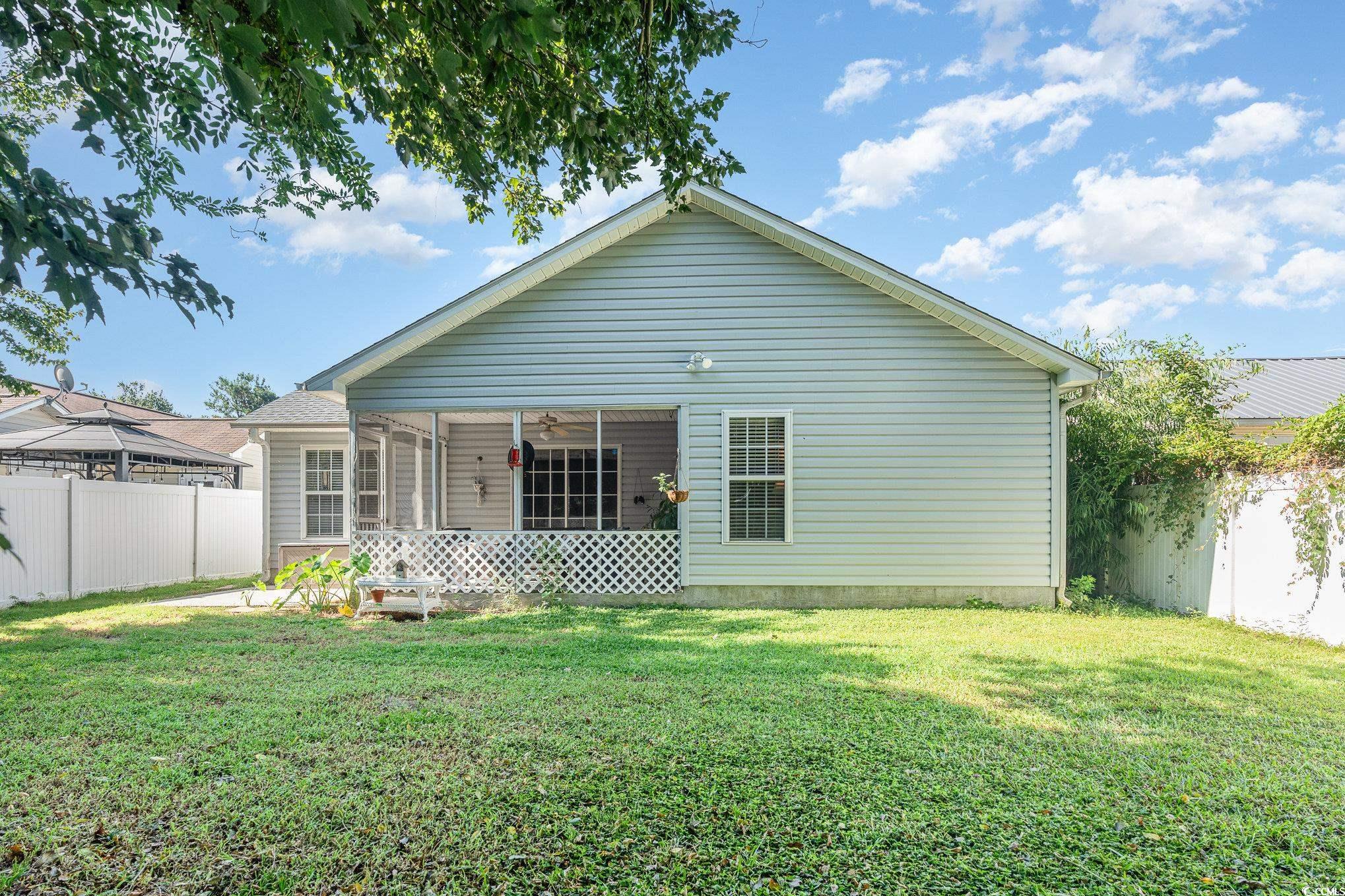1005 Autumn Drive Murrells Inlet, SC 29576 - Photo 3 of 25 Back of house featuring a lawn