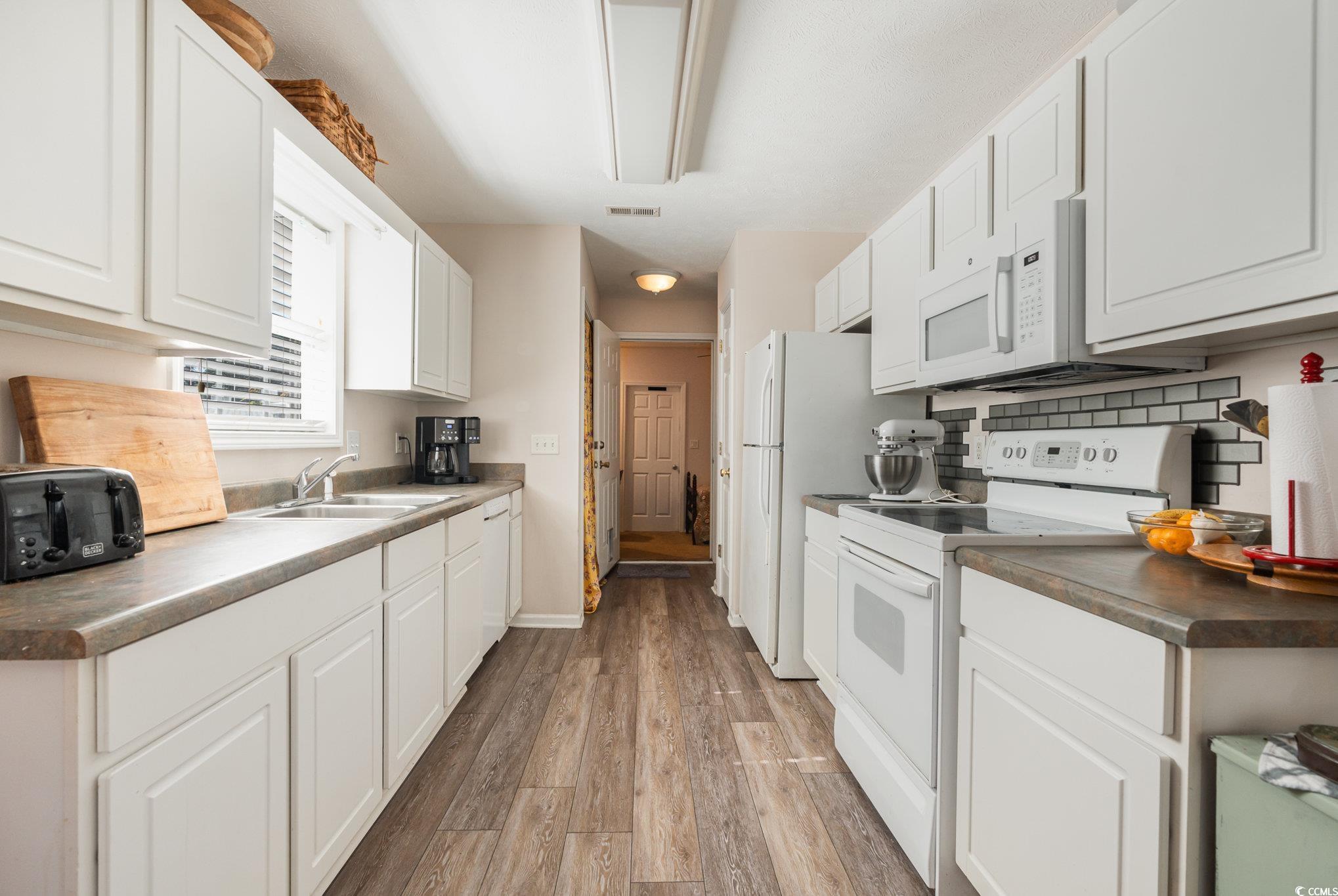 1005 Autumn Drive Murrells Inlet, SC 29576 - Photo 10 of 25 Kitchen with sink, decorative backsplash, white ap