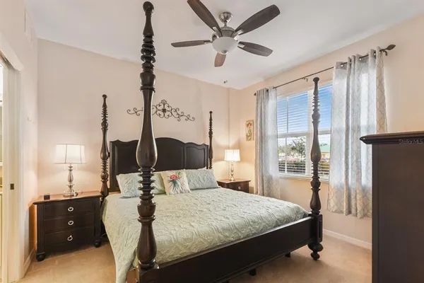 a bedroom with a bed and a flat tv screen