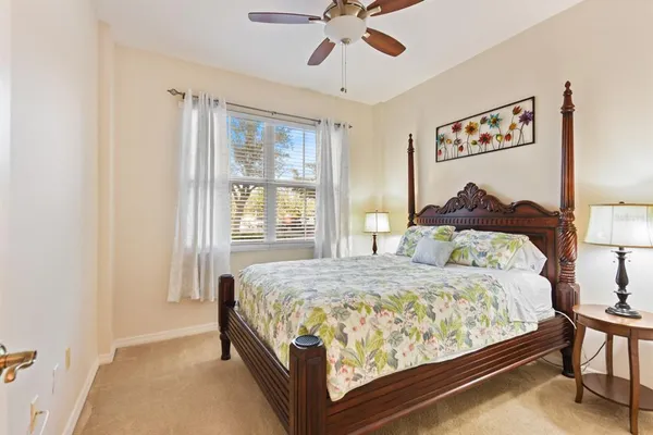 a bedroom with a bed and a painting on the wall
