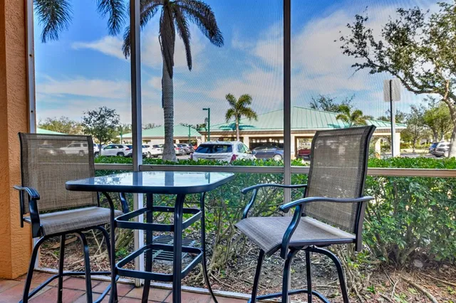 a view of a chairs and table in patio