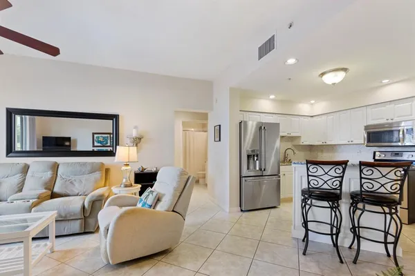 a kitchen with stainless steel appliances granite countertop sink refrigerator and cabinets