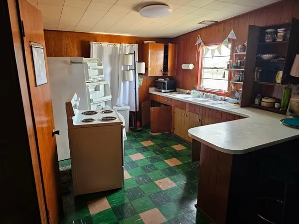 a kitchen with a sink cabinets and window