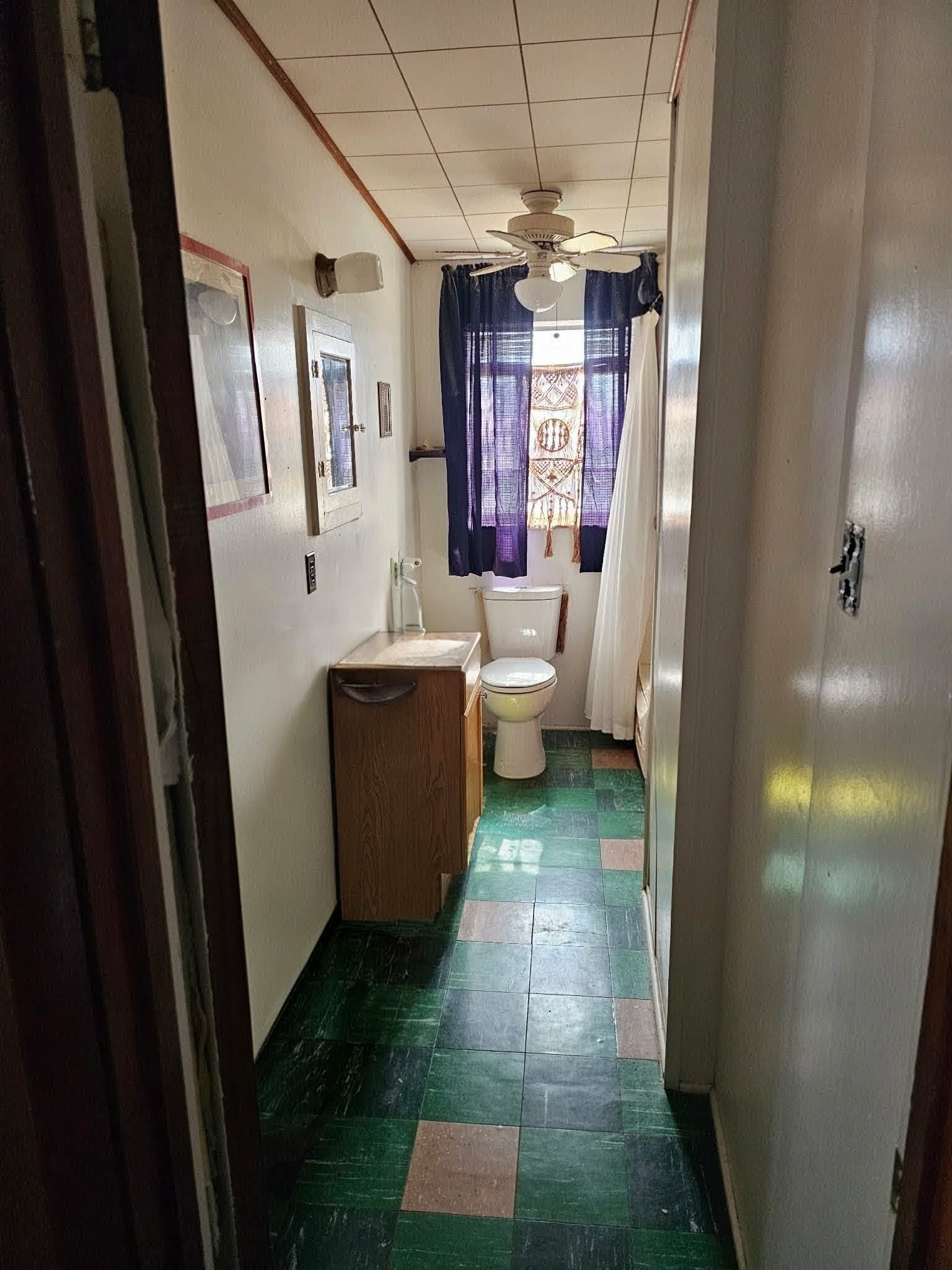 605 Texas Street Surfside Beach, TX 77541 - Photo 7 of 8 a bathroom with a sink a large mirror and a shower