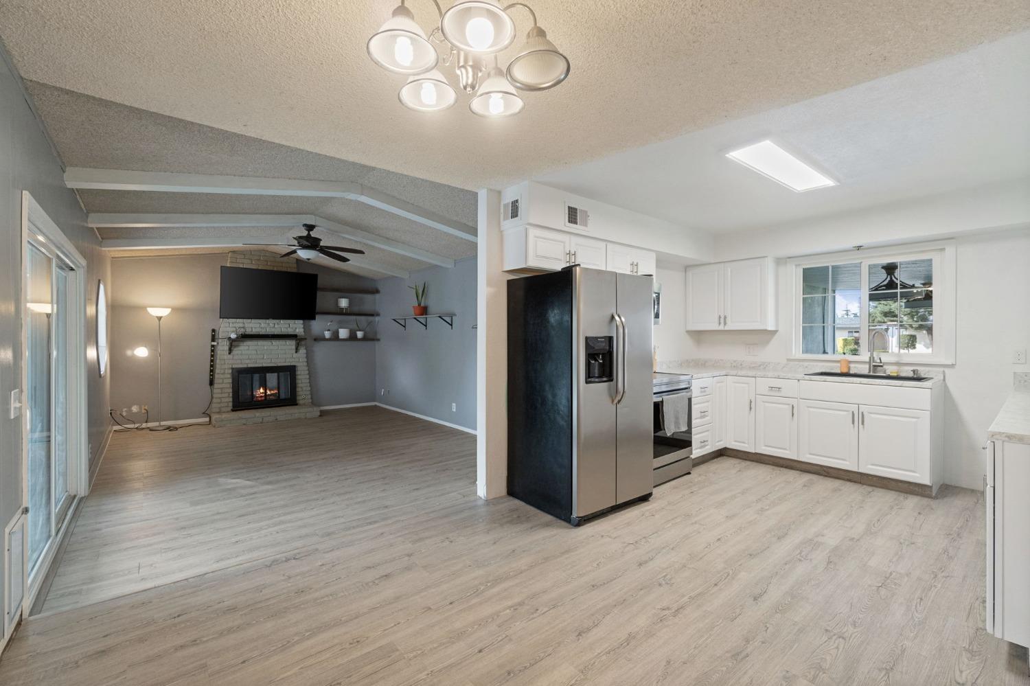 1443 Fairmont Avenue Clovis, CA 93611 - Photo 11 of 35 a kitchen with a refrigerator and a sink