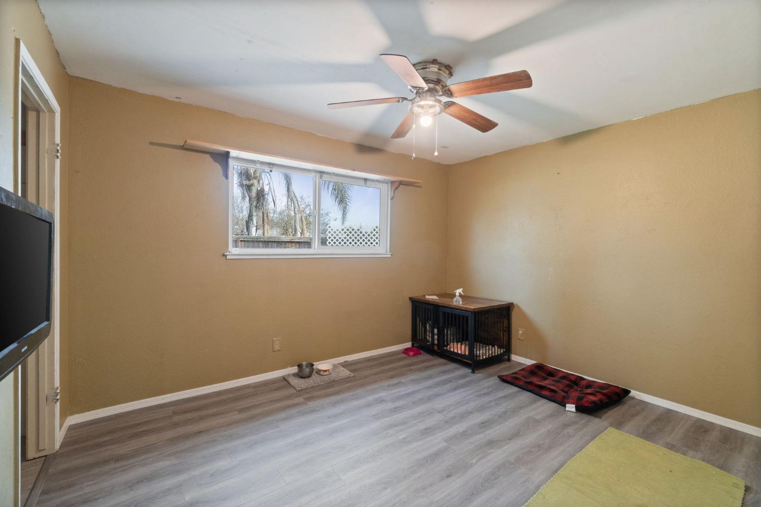 1443 Fairmont Avenue Clovis, CA 93611 - Photo 17 of 35 a bedroom with a bed and wooden floor