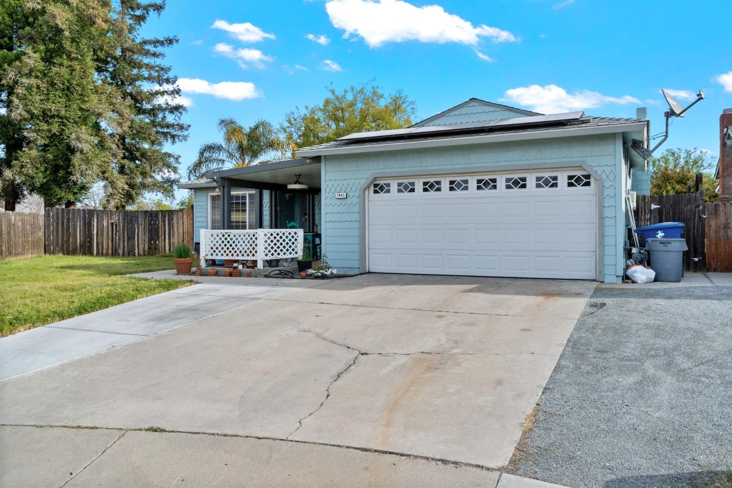 1443 Fairmont Avenue Clovis, CA 93611 - Photo 5 of 35 a front view of a building with a garden