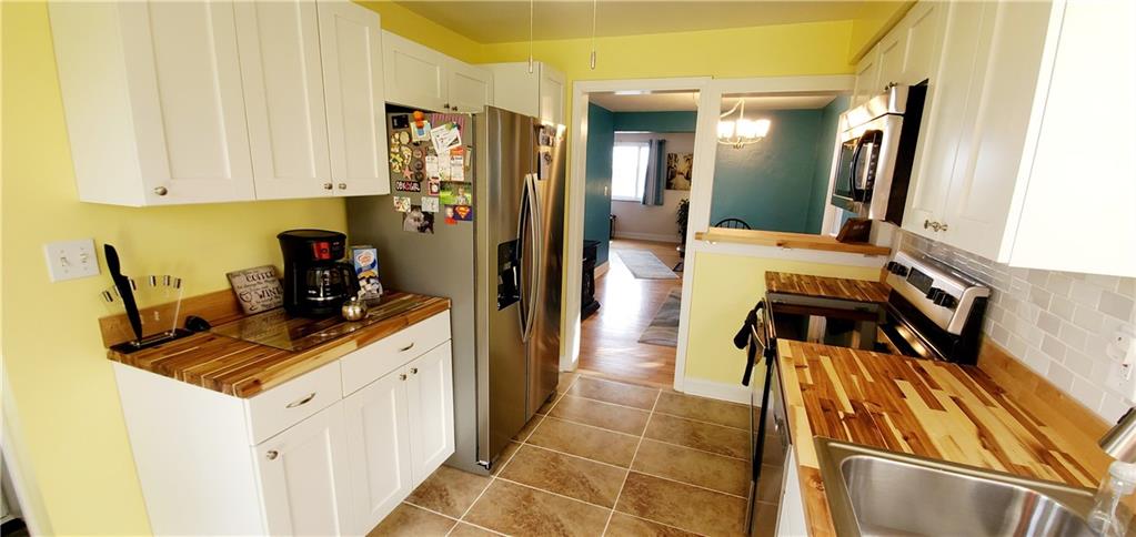 8117 Peebles Road Pittsburgh, PA 15237 - Photo 7 of 20 a kitchen with a sink and cabinets