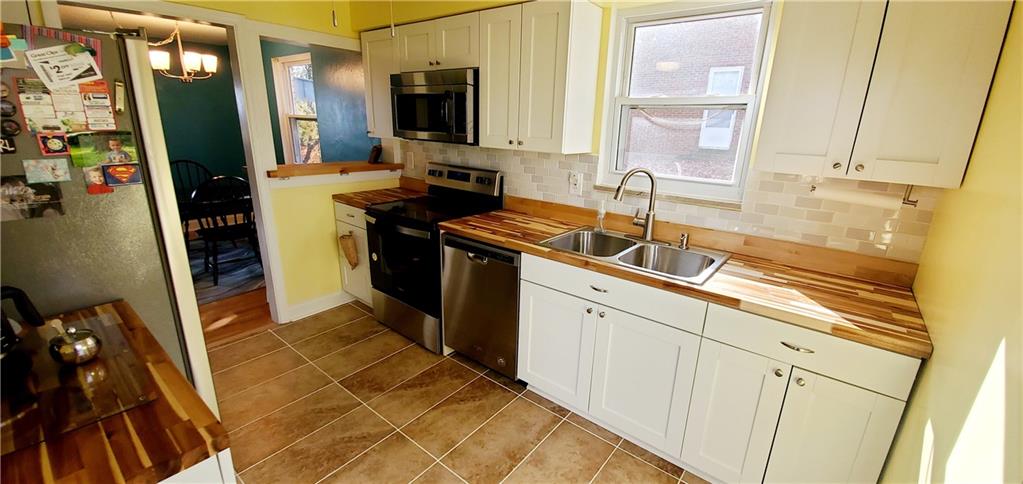 8117 Peebles Road Pittsburgh, PA 15237 - Photo 8 of 20 a kitchen with a sink and a refrigerator
