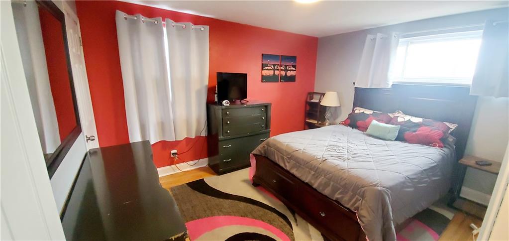 8117 Peebles Road Pittsburgh, PA 15237 - Photo 9 of 20 a bedroom with a bed and a flat screen tv