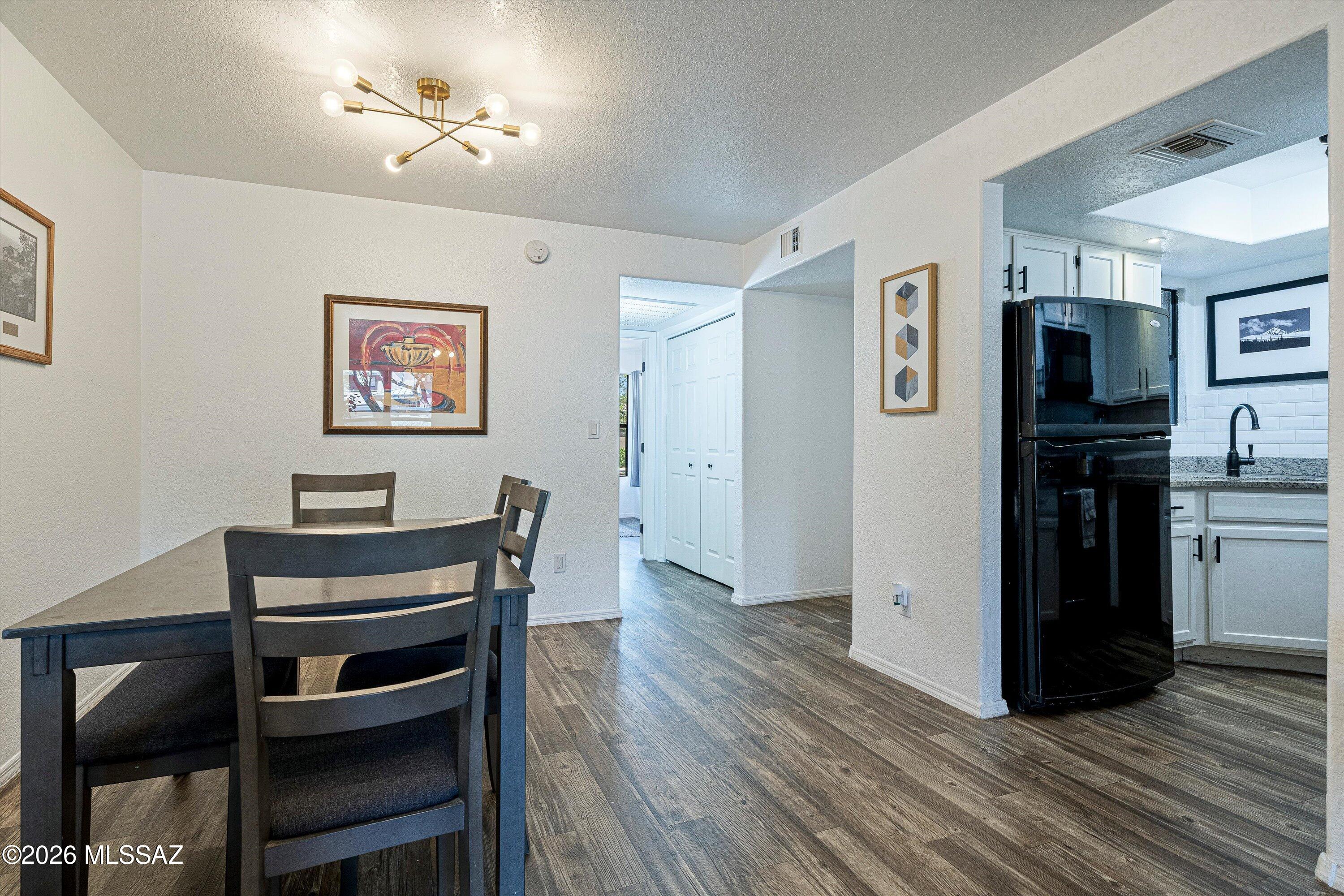5800 North Kolb Road, Unit 1102 Tucson, AZ 85750 - Photo 8 of 36 a view of a workspace with furniture and wooden floor