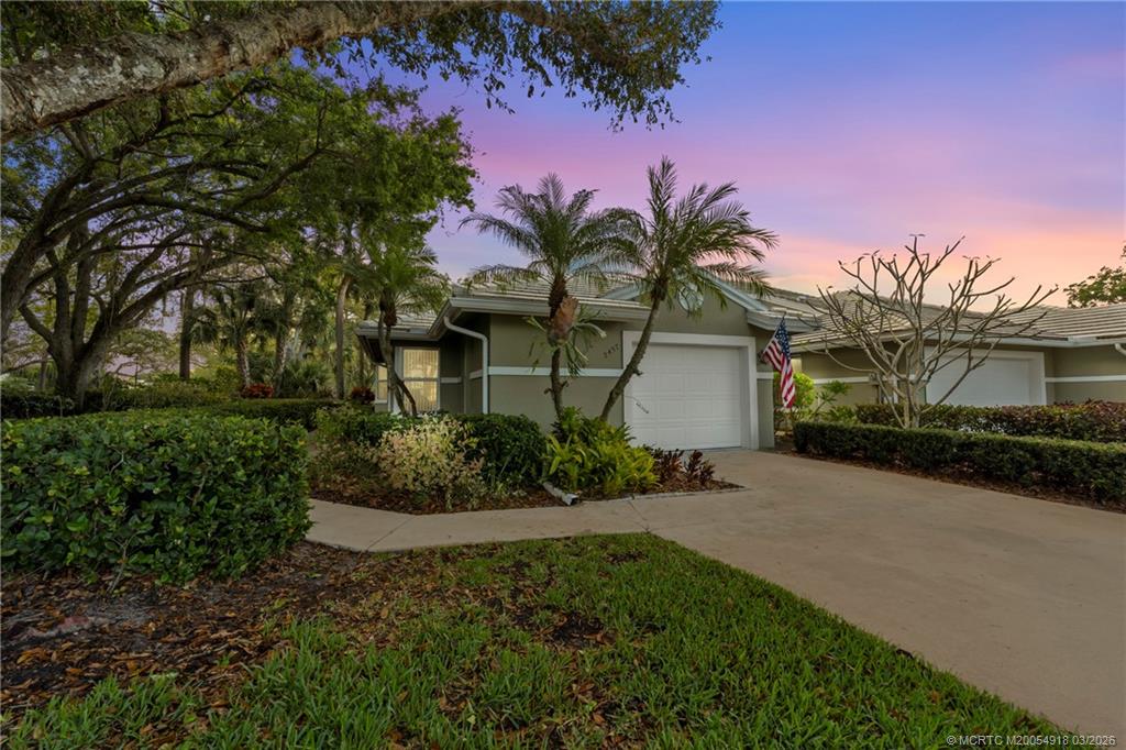 2437 Southwest Foxpoint Trail Palm City, FL 34990 - Photo 1 of 60 a front view of a house with a garden
