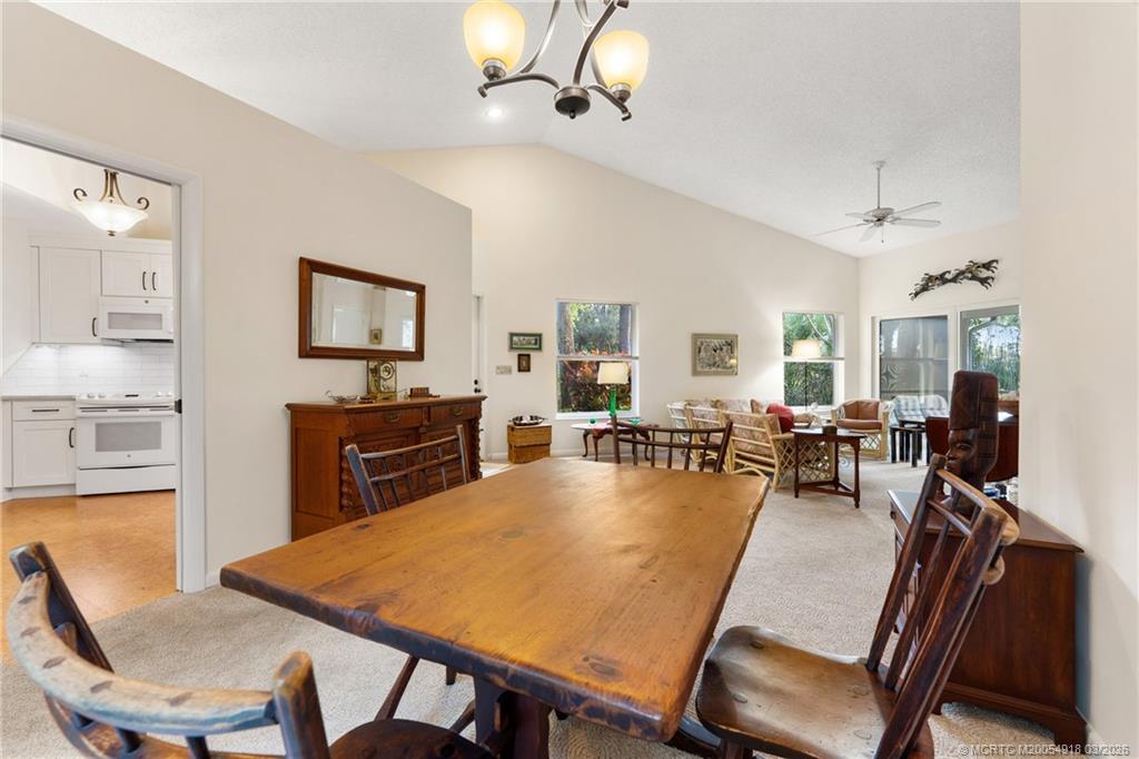 2437 Southwest Foxpoint Trail Palm City, FL 34990 - Photo 12 of 60 a view of a dining room with furniture window and wooden floor