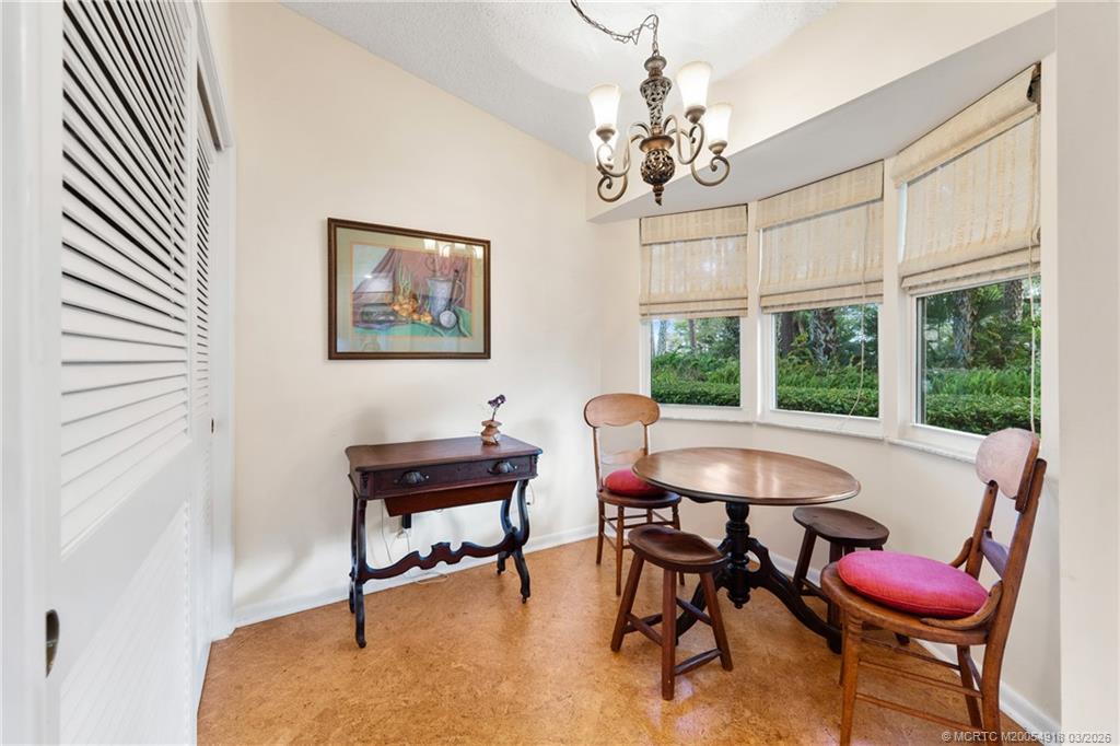 2437 Southwest Foxpoint Trail Palm City, FL 34990 - Photo 18 of 60 a view of a dining room with furniture and a chandelier