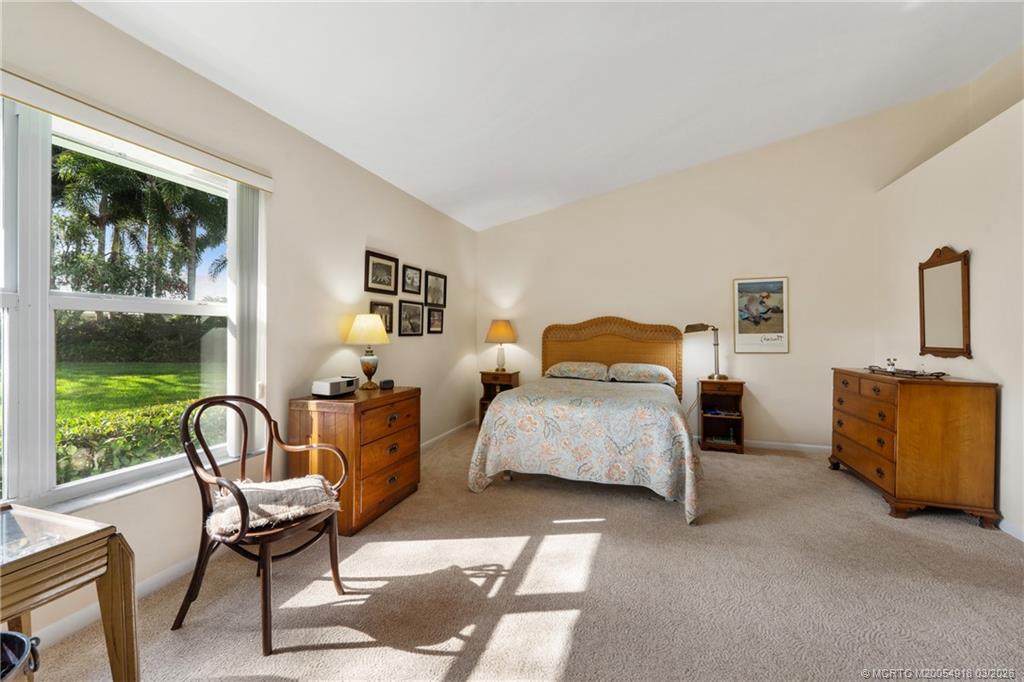 2437 Southwest Foxpoint Trail Palm City, FL 34990 - Photo 19 of 60 a bedroom with a bed chair and window