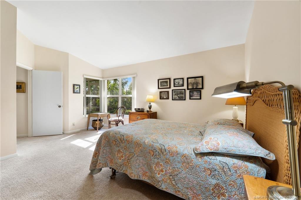 2437 Southwest Foxpoint Trail Palm City, FL 34990 - Photo 21 of 60 a bedroom with a bed and wooden floor